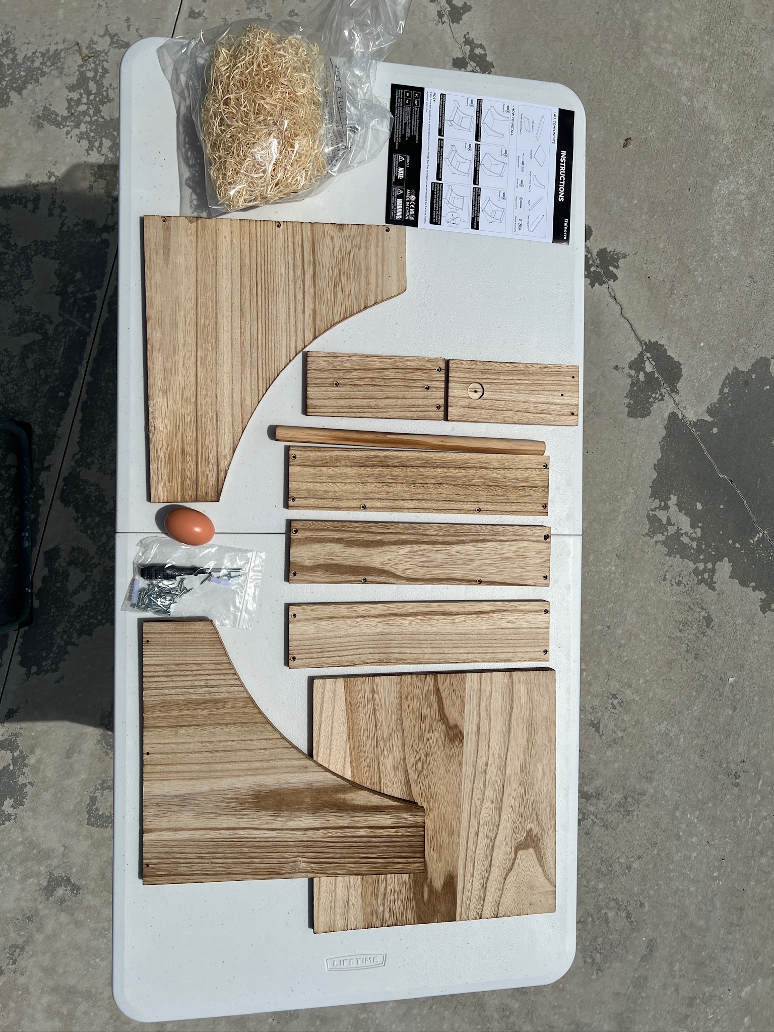 wood nesting box supplies on a white table.